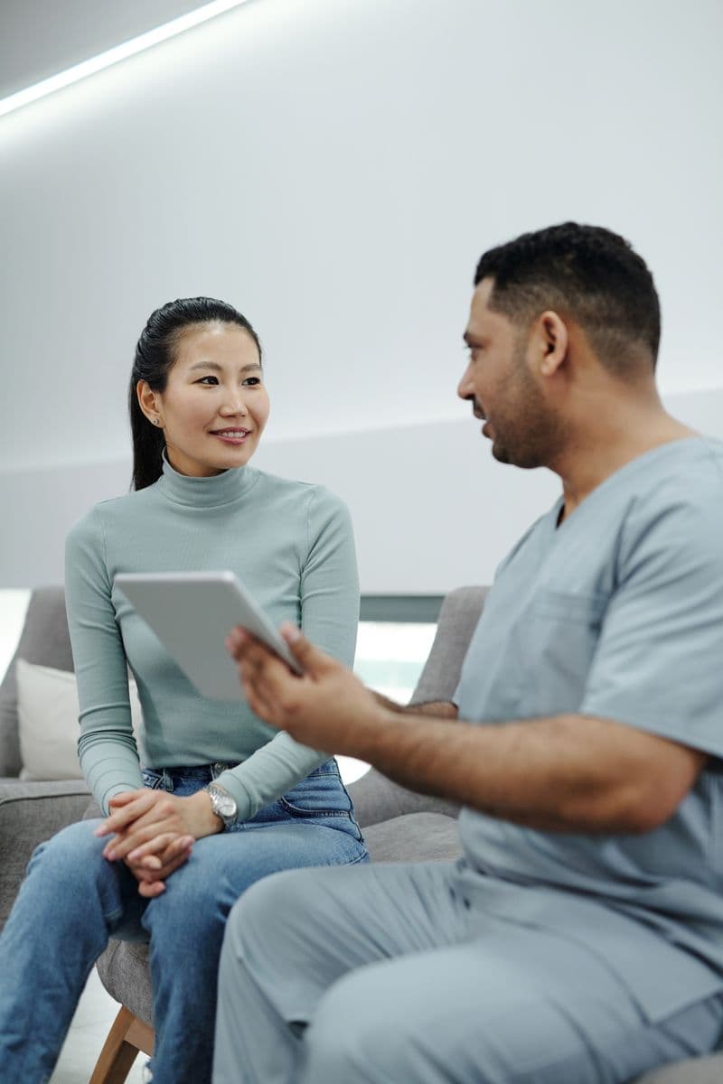 A patient and a clinician talking through results together in a consulting room.